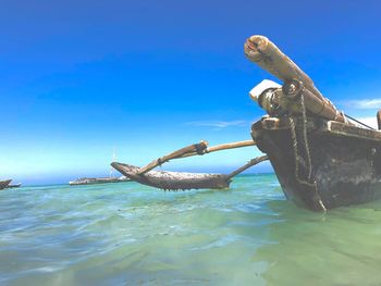 View of boat in sea against blue sky