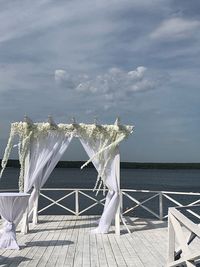 Built structure by sea against sky