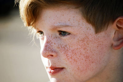 Close-up portrait of boy looking away