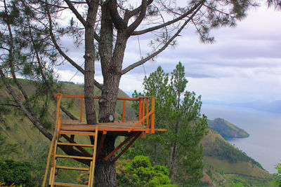 Built structure by trees against sky
