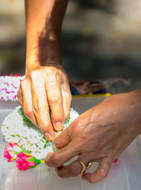 Midsection of man holding flower