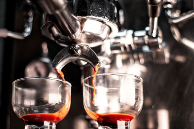 Close-up of wine pouring coffee in glass