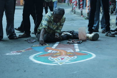 Man drawing on road