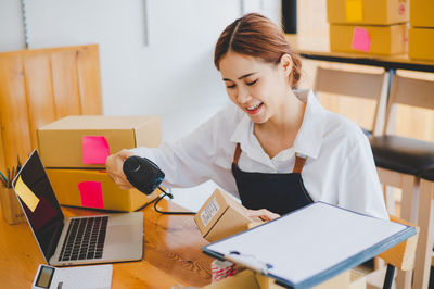 Businesswoman using laptop at office