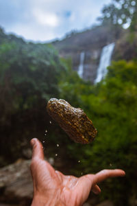 Cropped hand of person holding rock