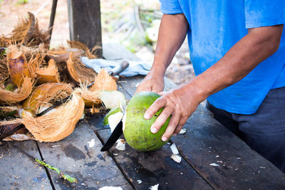 Man preparing coconut