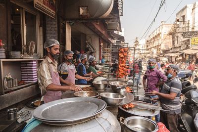 Group of people at market stall in city