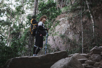 Young man on rock in forest