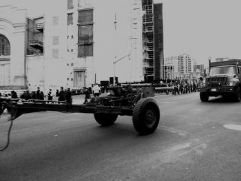 Cars on city street against clear sky