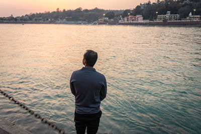 Rear view of man standing in lake