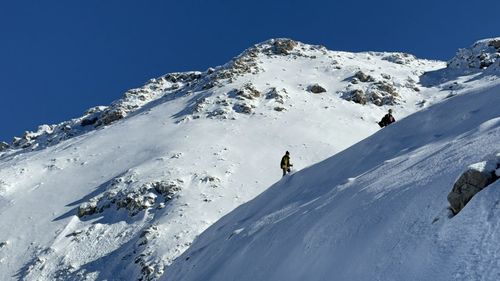 People skiing on snowcapped mountain