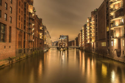 View of canal in city at night