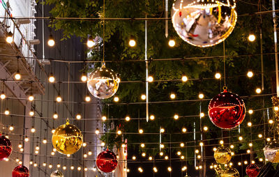 Low angle view of illuminated christmas lights at night