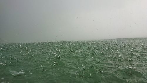 Water splashing in sea against sky