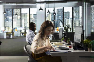 Young woman using mobile phone in cafe