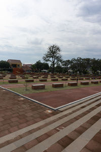 Park by buildings against sky in city