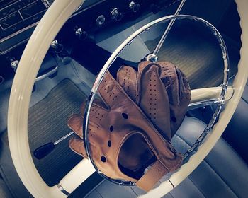 Leather gloves on steering wheel of vintage car