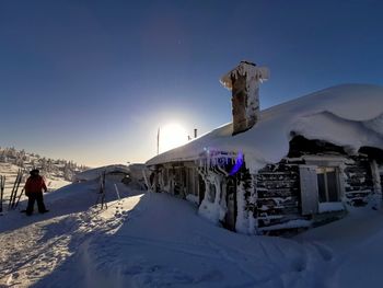 People on snow covered mountain against sky