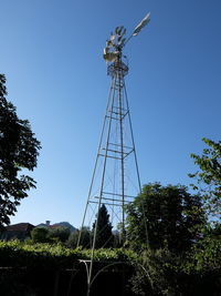 Low angle view of windmill against clear blue sky