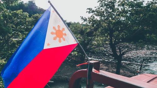 Close-up of flag against trees