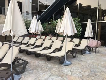 Closed parasols with deck chairs at hotel