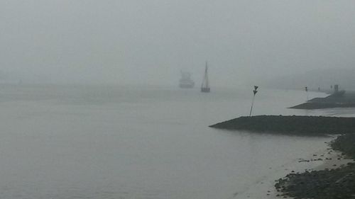Scenic view of sea against cloudy sky