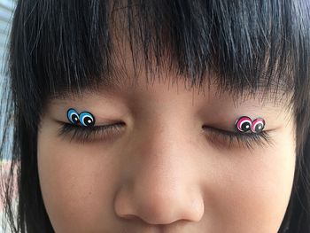 Close-up of girl with stickers on eyes