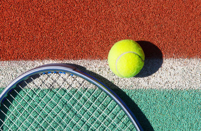 Directly above shot of tennis racket and ball