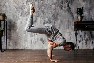 A man with strong body engaged in yoga and meditation, performing asanas