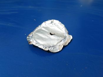 High angle view of umbrella on table against blue background