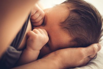 Close-up of baby sleeping on bed