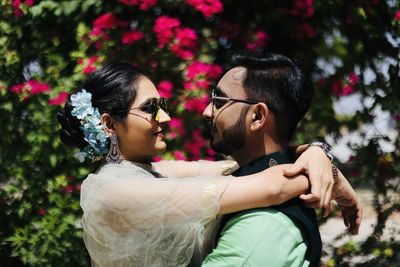 Side view of couple kissing on plants