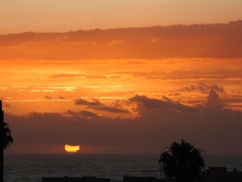 Scenic view of sea against romantic sky at sunset