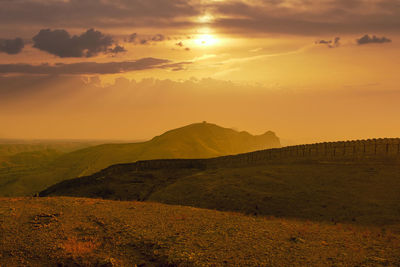 Scenic view of mountains against sky during sunset