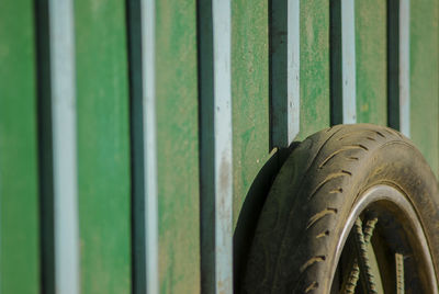 Close-up of tire leaning on wall
