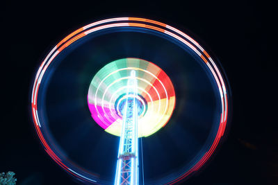 Low angle view of illuminated ferris wheel at night