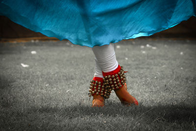 Low section of woman dancing on grass