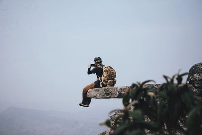 Low angle view of man against clear sky