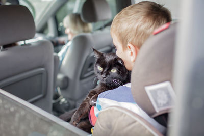 Family of ukrainian refugees, seniors and kids, fleeing from war against russia together with pet