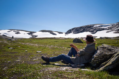 Man having a rest while hiking in the mountains