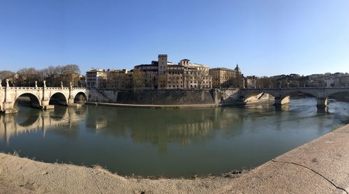 Arch bridge over river against sky