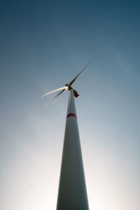 Low angle view of windmill against clear blue sky