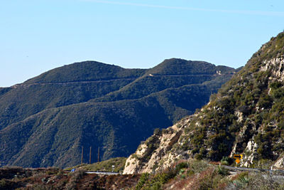 Scenic view of mountains against clear blue sky