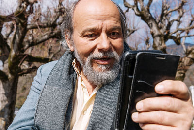 Portrait of a confident, handsome, mature man, pensioner, grandfather in the small town