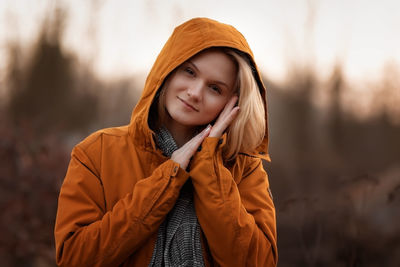 Portrait of young woman standing in forest