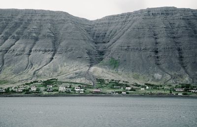 Scenic view of the small village on the mountain foot in the west fjord of iceland