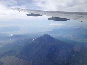 Cropped image of airplane flying over landscape