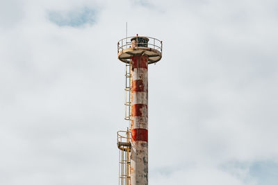 Low angle view of communications tower against sky