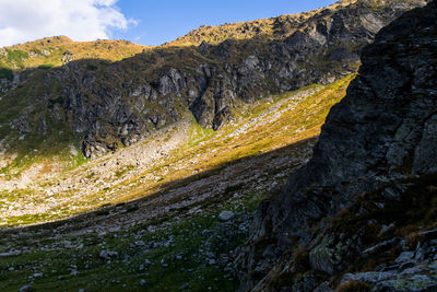 Scenic view of land and mountains against sky