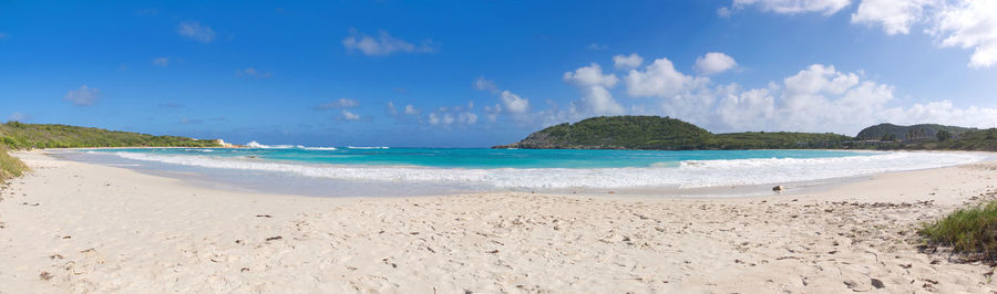 Panoramic view of beach against blue sky